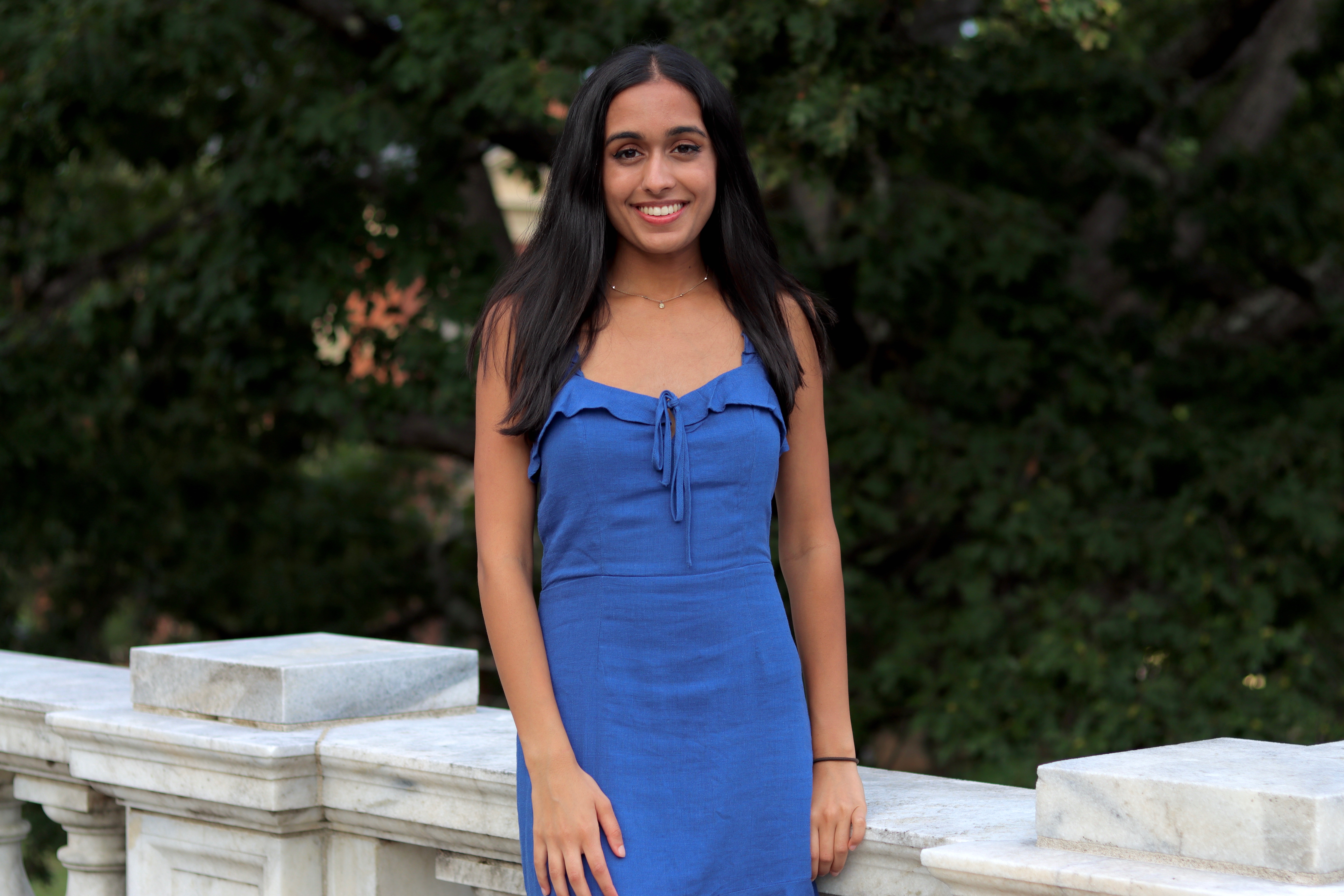 Shreyal in a blue dress looking at the camera, standing at Rotunda