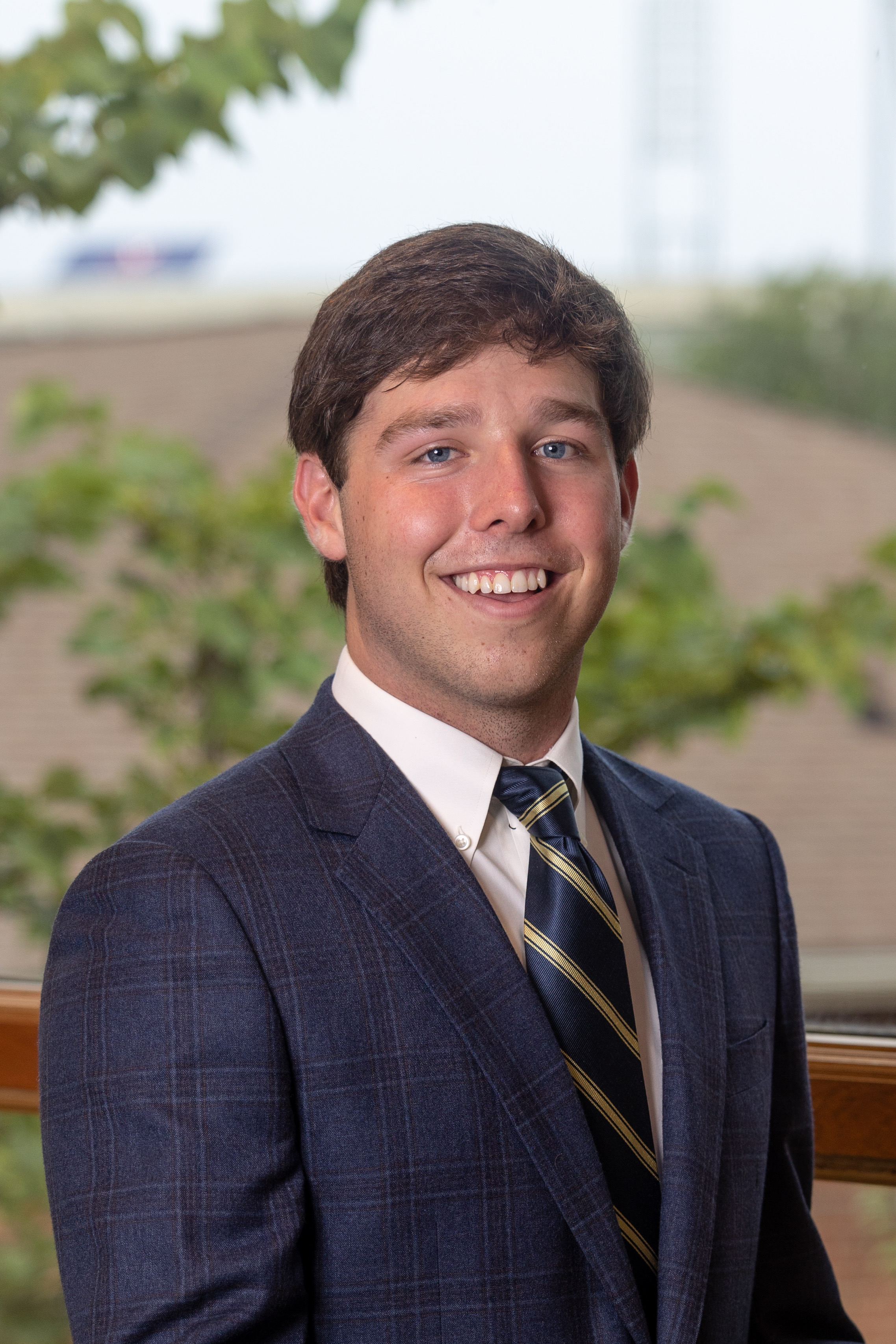 headshot of ben wearing a suit and tie