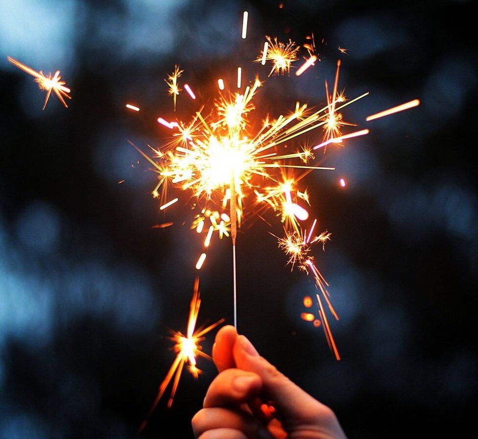 Closeup of hand holding lit up sparkler. Photo courtesy of Karen Walrond