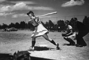 <p><span style="font-size:12px"><strong><em>"It's a hit and batter Dottie Schroeder, blonde pigtails and all, start[s] running for first. These girls really hit...and are lightning when running."</em> (April 22, 1948) &nbsp;</strong>Dorothy "Dottie" Schroeder&nbsp;became the All-American Girls Professional Baseball League's youngest player at age 15 and was the only girl who played all 12 seasons for the AAGPBL.</span></p>
