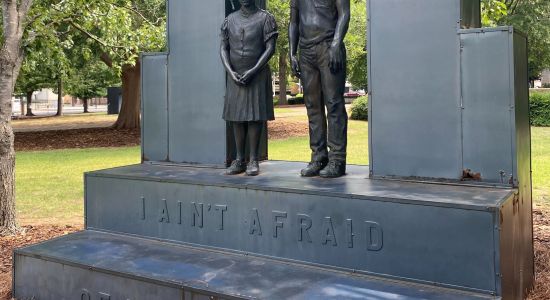 Statue of girl and boy on pedestal reading "I ain't afraid of your jail"