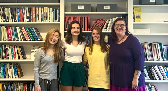 YWLP interns and staff 2023-24 standing in front of bookshelf in women's center conference room