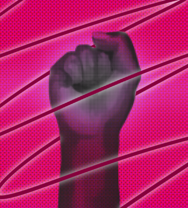 Fist held up against pink background
