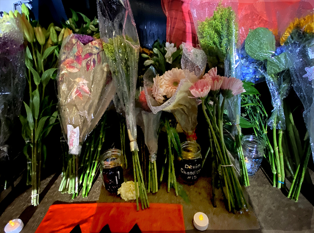 votives and flowers in stadium memorial area